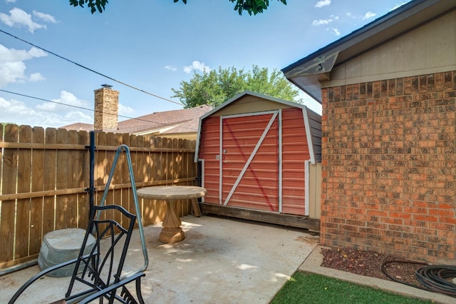 view of patio featuring a storage shed