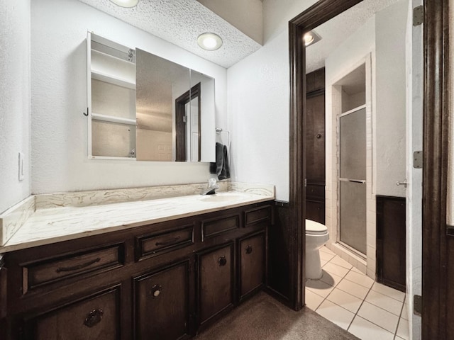 bathroom with an enclosed shower, tile patterned floors, a textured ceiling, and toilet