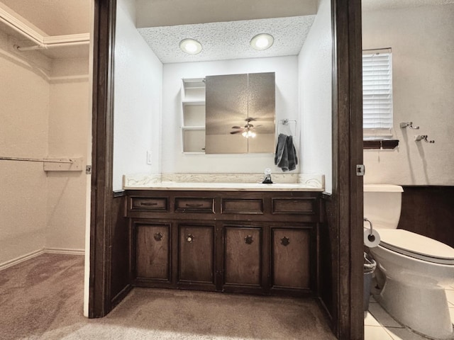 bathroom with vanity, toilet, and a textured ceiling