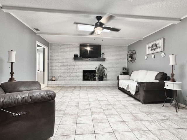 living room featuring brick wall, beamed ceiling, ceiling fan, a brick fireplace, and a textured ceiling