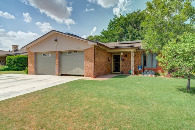 ranch-style house featuring a garage, a front lawn, and solar panels