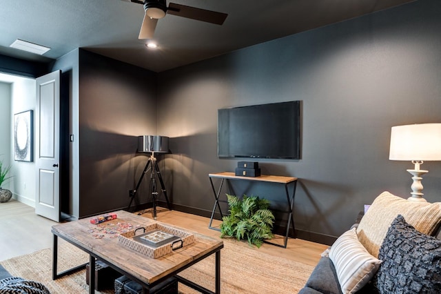 living room featuring ceiling fan and light hardwood / wood-style floors