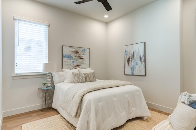 bedroom with ceiling fan and light hardwood / wood-style floors