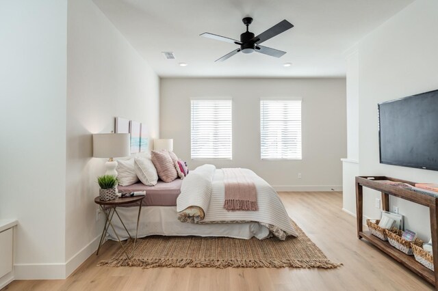 bedroom with ceiling fan and light wood-type flooring