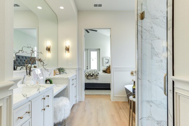 bathroom with hardwood / wood-style flooring and vanity