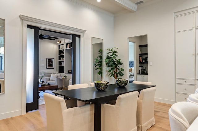 dining area featuring crown molding, ceiling fan, and light hardwood / wood-style floors