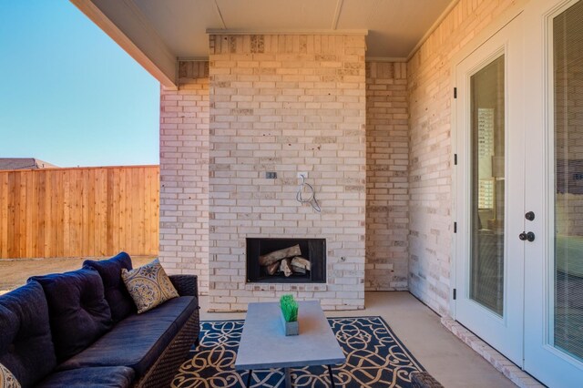 view of patio / terrace with an outdoor living space with a fireplace