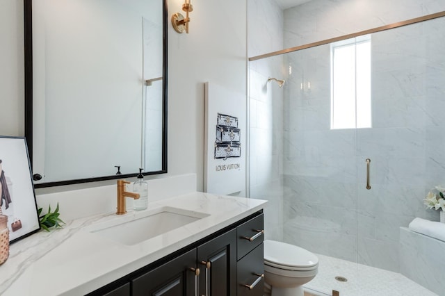 bathroom featuring vanity, an enclosed shower, and toilet