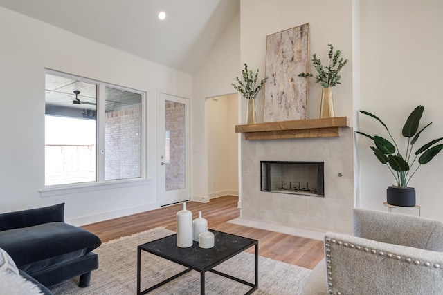 4610 138th Pl, Lubbock, TX 79424 - living room featuring vaulted ceiling, wood finished floors, a tile fireplace, and recessed lighting