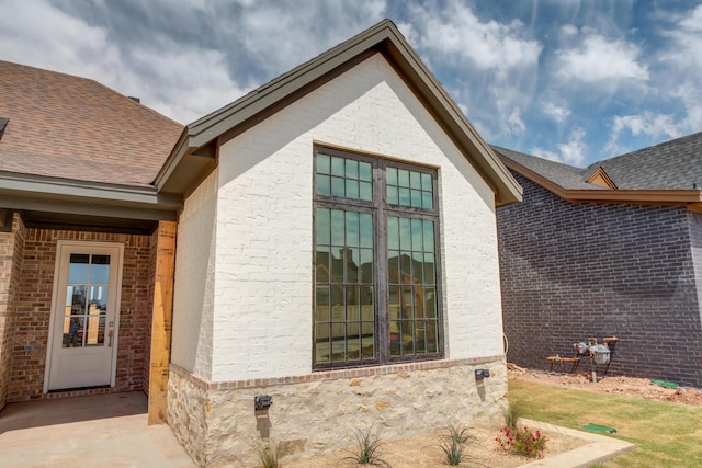 4610 138th Pl, Lubbock, TX 79424 - view of property exterior featuring a shingled roof and brick siding