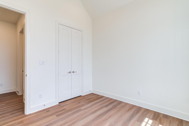 4610 138th Pl, Lubbock, TX 79424 - unfurnished bedroom with a closet, light wood-style flooring, and vaulted ceiling