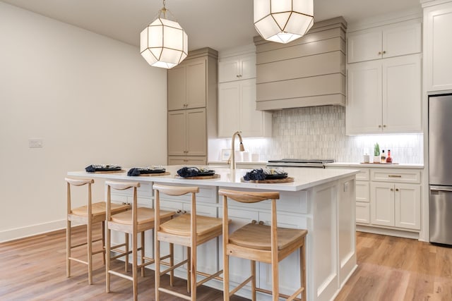 4610 138th Pl, Lubbock, TX 79424 - kitchen featuring stainless steel refrigerator, light countertops, light wood-type flooring, decorative backsplash, and custom range hood