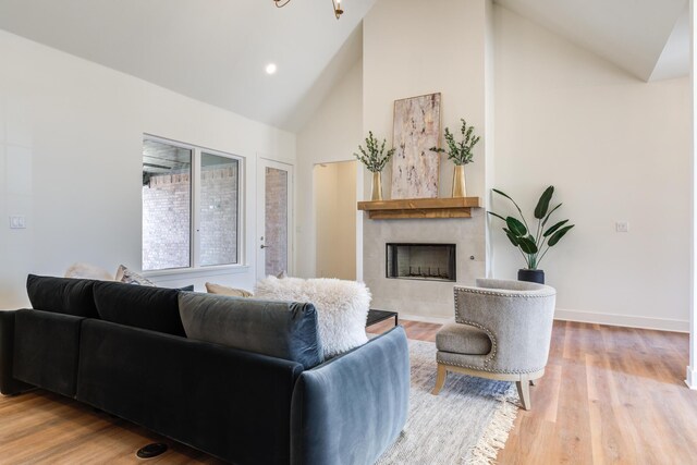 4610 138th Pl, Lubbock, TX 79424 - living room featuring a tile fireplace, wood finished floors, and high vaulted ceiling