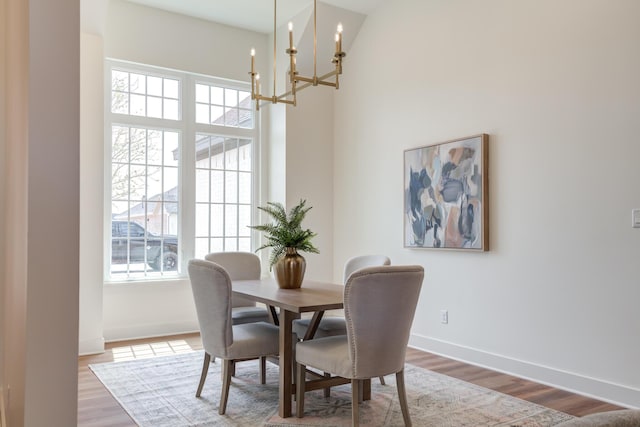 4610 138th Pl, Lubbock, TX 79424 - dining room with a chandelier, wood finished floors, and a high ceiling