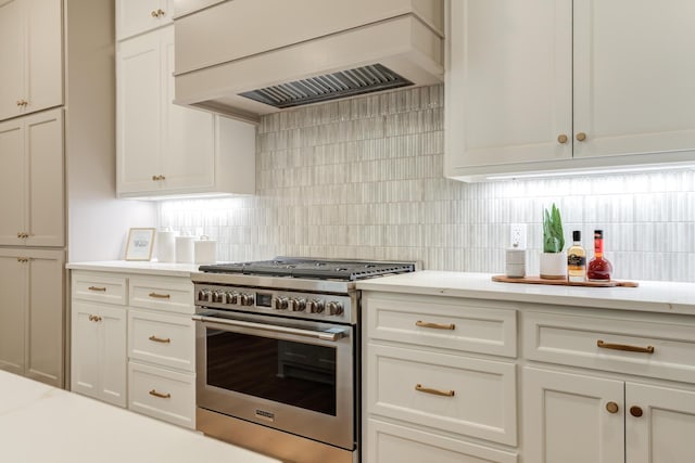 4610 138th Pl, Lubbock, TX 79424 - kitchen with high end stove, premium range hood, tasteful backsplash, and white cabinets