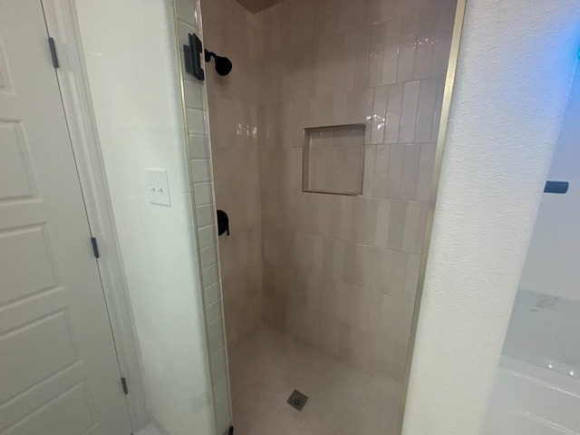 bathroom with a tile shower