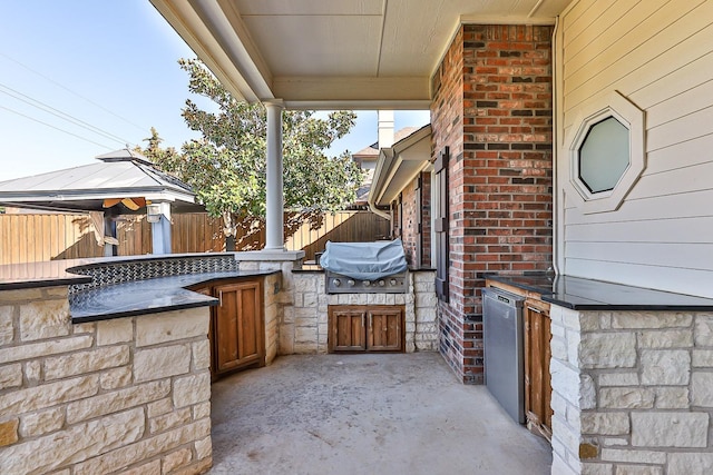 view of patio featuring a gazebo, an outdoor kitchen, and grilling area