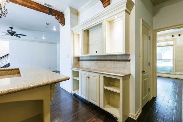 kitchen featuring dark hardwood / wood-style flooring, backsplash, beamed ceiling, and ceiling fan