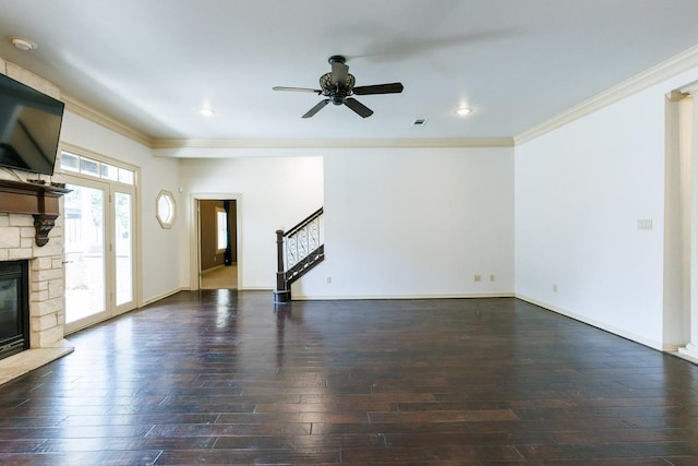 unfurnished living room featuring crown molding, dark hardwood / wood-style floors, a fireplace, and ceiling fan