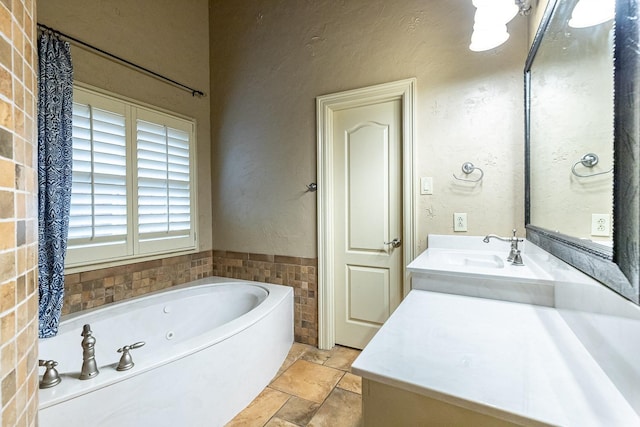 bathroom featuring vanity and a tub to relax in