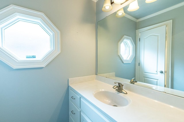 bathroom with vanity, plenty of natural light, and ornamental molding