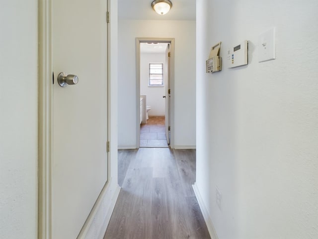 corridor featuring wood-type flooring