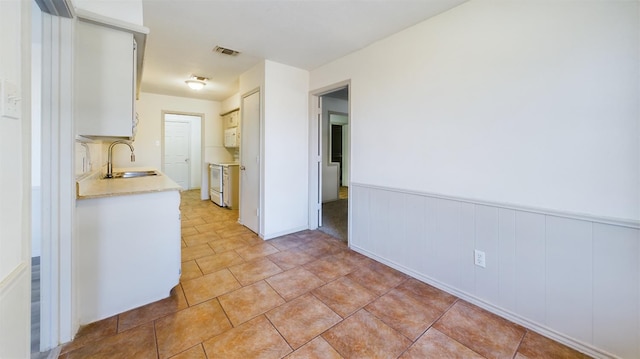 interior space with sink and light tile patterned floors