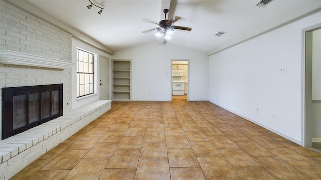 unfurnished living room featuring light tile patterned floors, rail lighting, ceiling fan, a brick fireplace, and vaulted ceiling