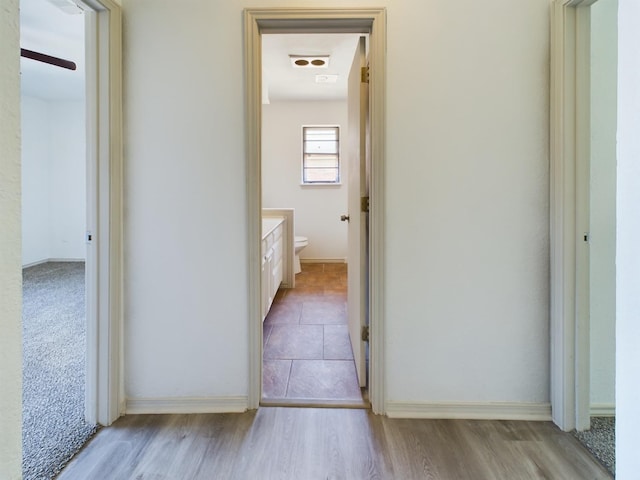 corridor with light hardwood / wood-style flooring