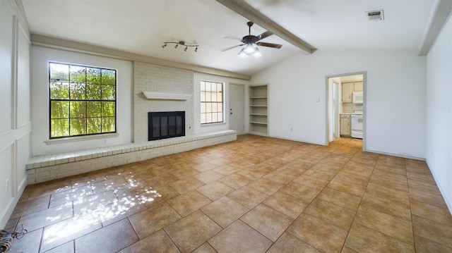 unfurnished living room featuring ceiling fan, vaulted ceiling with beams, light tile patterned floors, and a fireplace