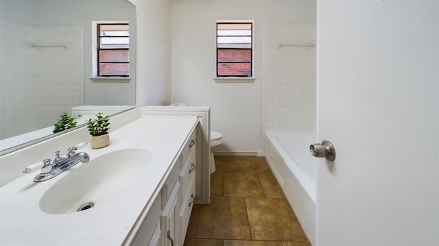 full bathroom with vanity, tiled shower / bath, tile patterned floors, and toilet