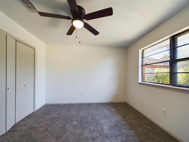 unfurnished bedroom featuring carpet, ceiling fan, and a closet