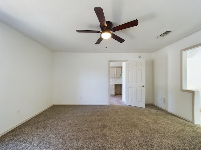 carpeted empty room featuring ceiling fan