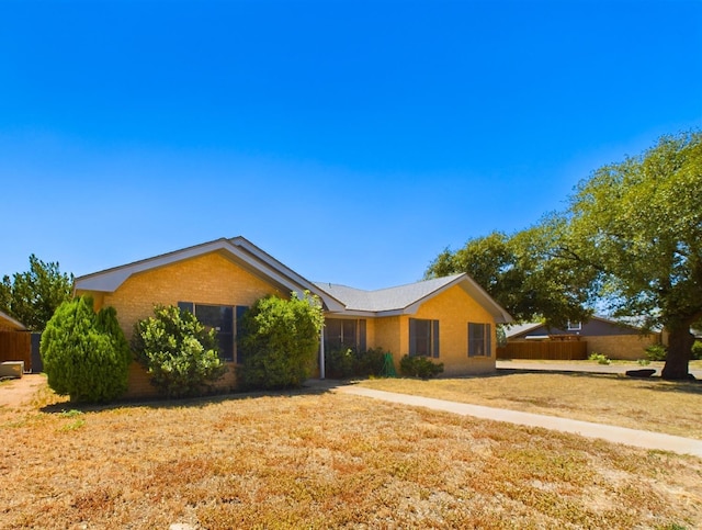 ranch-style home featuring a front lawn