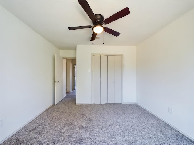 unfurnished bedroom featuring light carpet, a closet, and ceiling fan