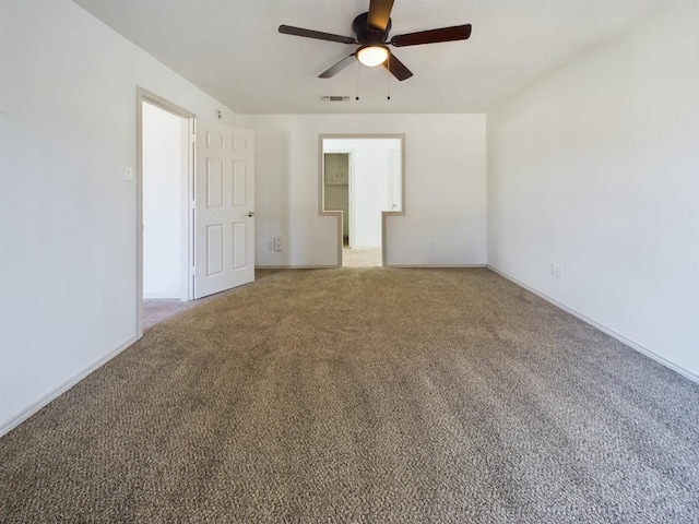 carpeted spare room with ceiling fan