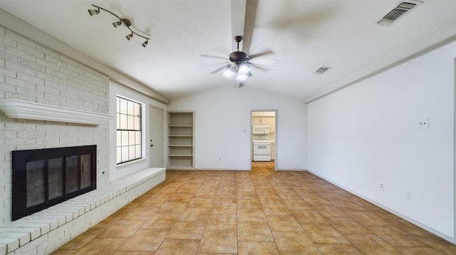 unfurnished living room featuring vaulted ceiling, light tile patterned floors, ceiling fan, a brick fireplace, and track lighting