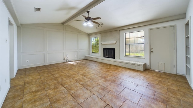 unfurnished living room featuring ceiling fan, vaulted ceiling with beams, light tile patterned floors, and a fireplace