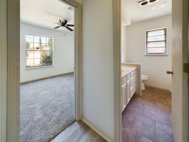 bathroom featuring vanity, ceiling fan, and toilet