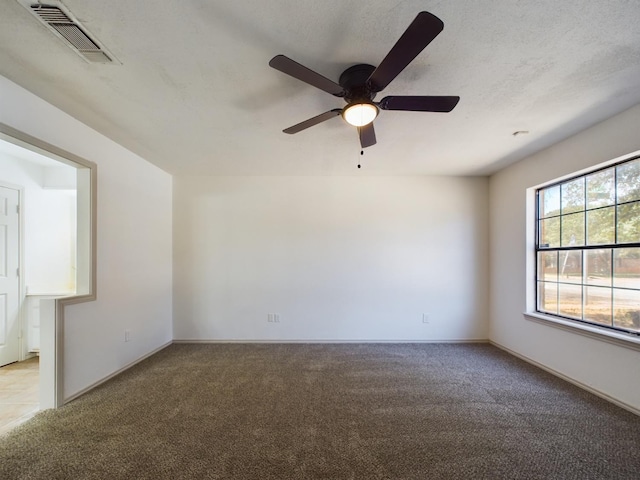 carpeted spare room featuring a textured ceiling