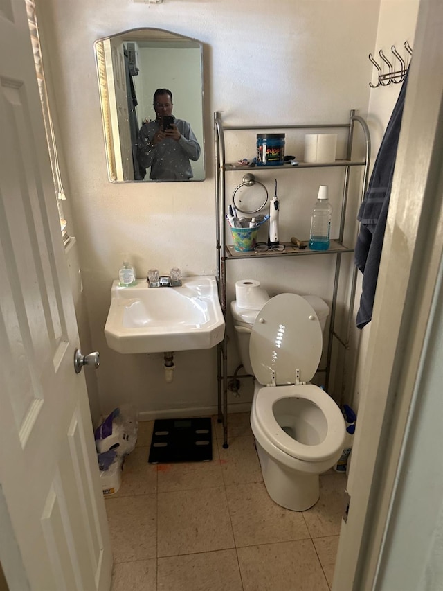 bathroom featuring tile patterned flooring, sink, and toilet