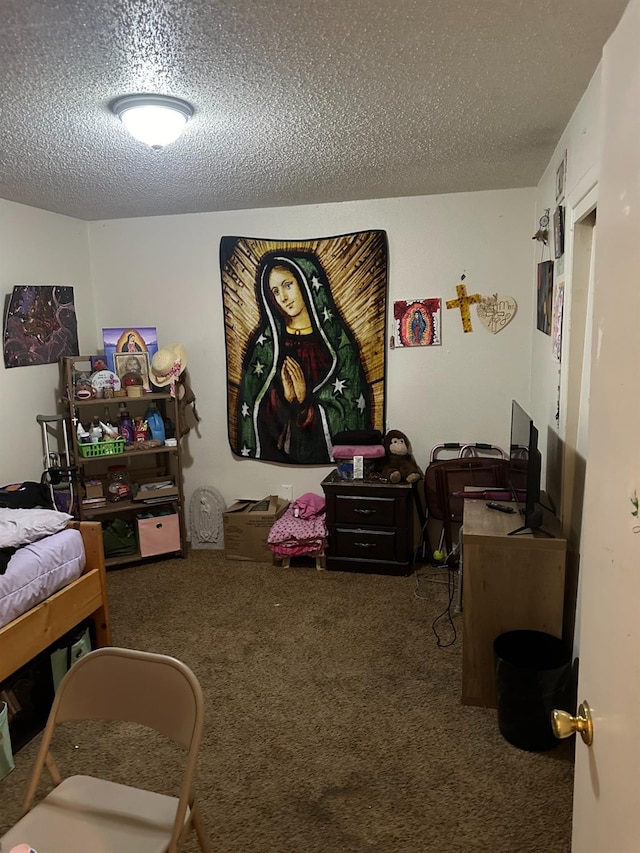 bedroom featuring carpet and a textured ceiling