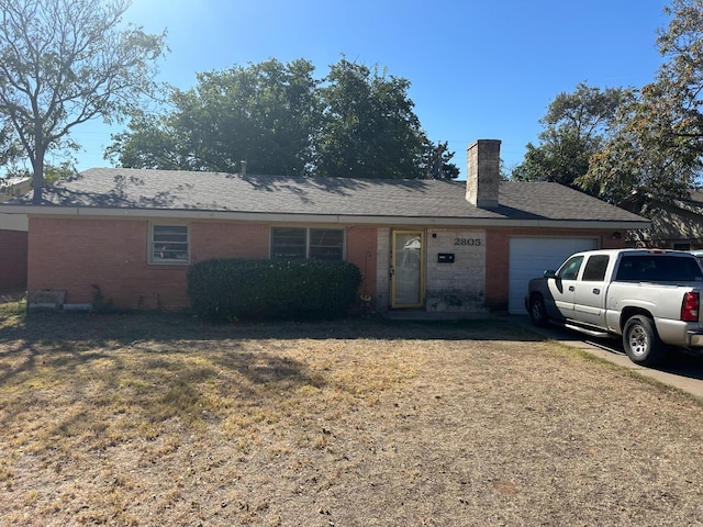 ranch-style home with a garage and a front yard