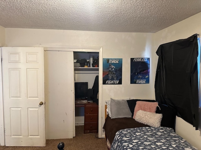 carpeted bedroom featuring a closet and a textured ceiling