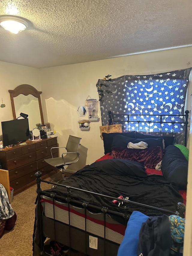 bedroom featuring carpet floors and a textured ceiling