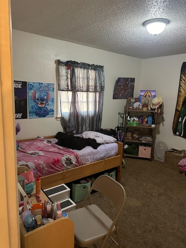 bedroom with a textured ceiling and carpet