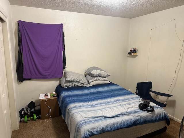 carpeted bedroom with a textured ceiling