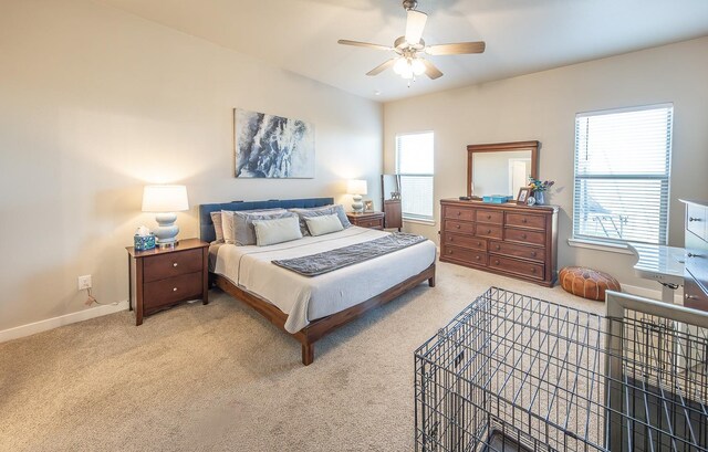 carpeted bedroom featuring multiple windows and ceiling fan