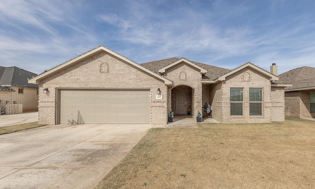 view of front of home with a garage and a front lawn