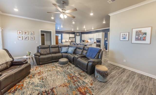 living room with ceiling fan, ornamental molding, and wood-type flooring